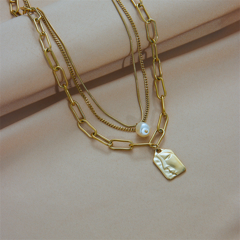 Layered gold face portrait necklace for women