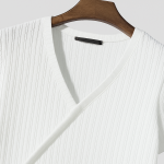 White ribbed knit V-neck sweater hanging on a polished wooden hanger against a light gray background