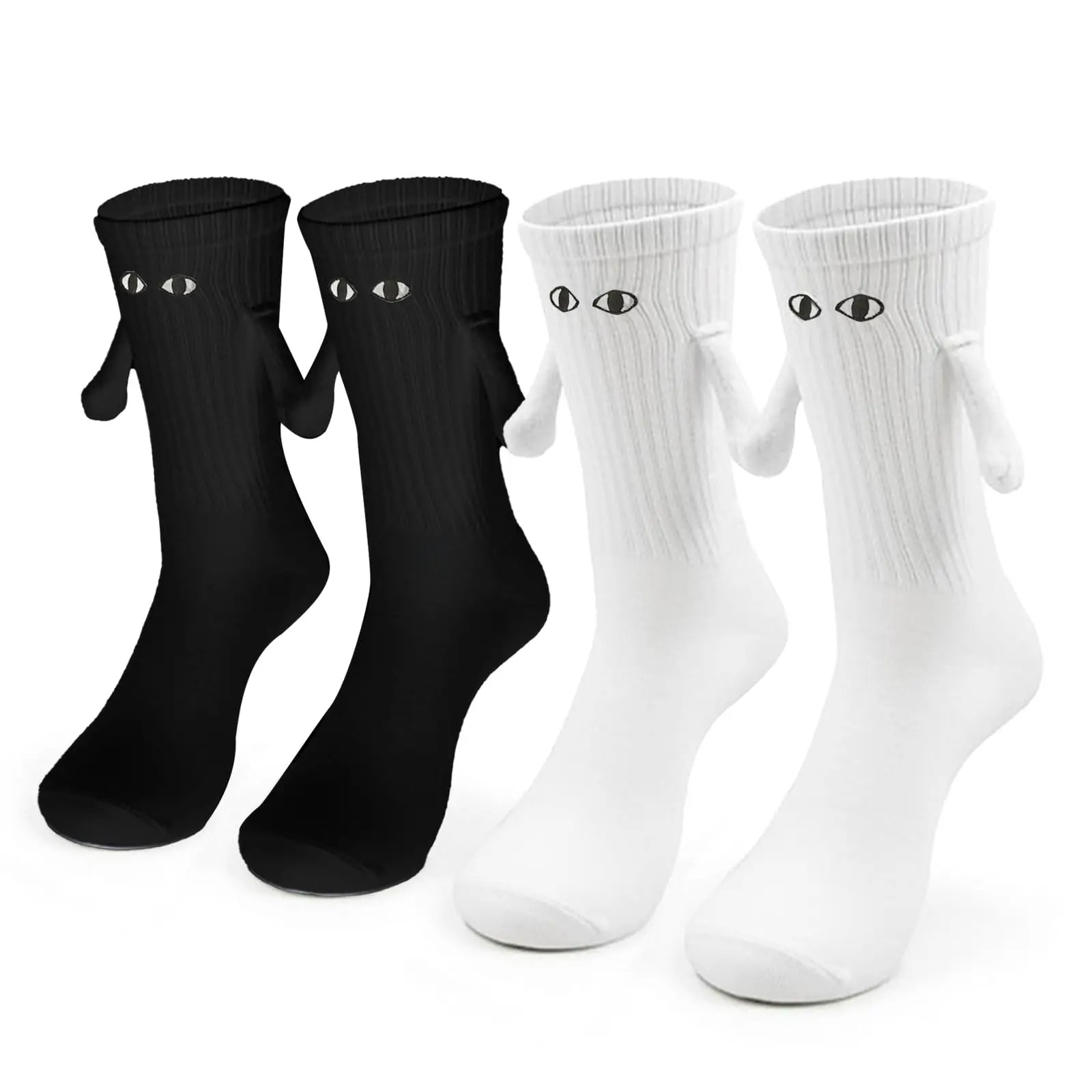 Four whimsical socks—two black and two white—each featuring embroidered eyes and tiny arms, arranged side by side on a neutral background.