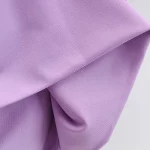 Close-up of folded lavender fabric with smooth texture and soft sheen.