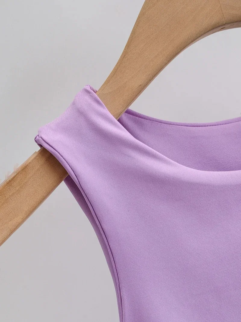 Light purple sleeveless top on a curved wooden hanger, showcasing smooth fabric texture.