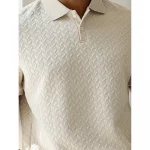 Close up model wearing a beige chevron-textured polo shirt, holding a minimalist coffee cup with a percentage symbol.